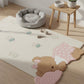 Children's room with a teddy bear rug, small table, and pet bed.