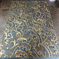 Decorative rug with intricate pattern on a concrete floor