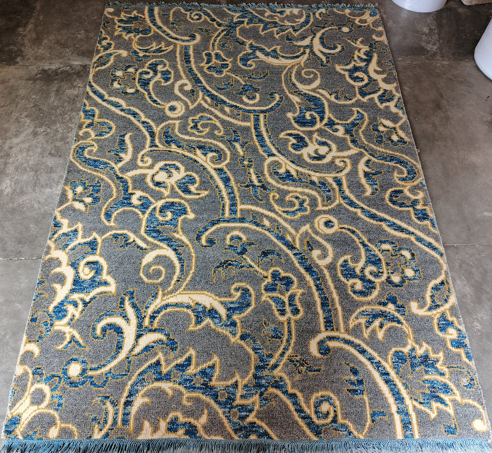 Decorative rug with intricate pattern on a concrete floor
