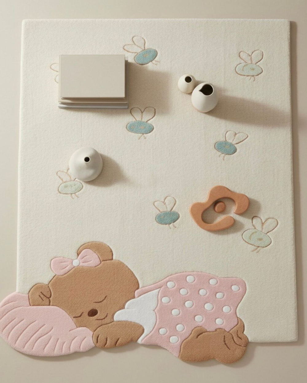 Baby play mat with teddy bear design and toys on a light background