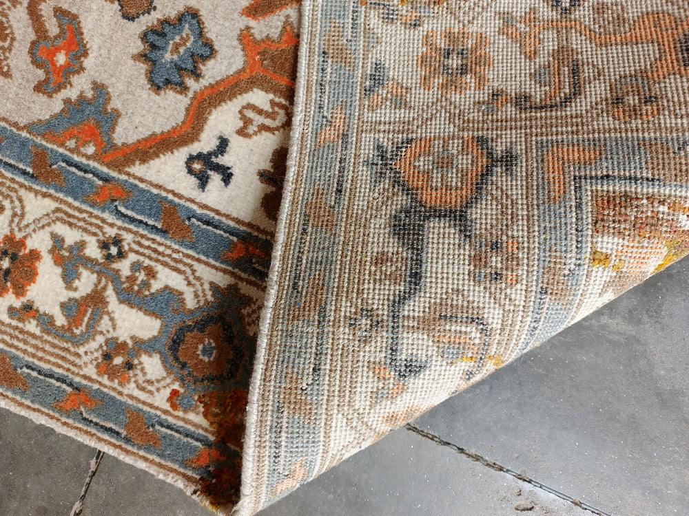 Close-up of a patterned rug on a tiled floor