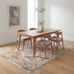 Dining room with wooden table and chairs on a patterned rug