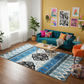 Living room with a blue sofa, colorful rug, and wall art.