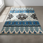Decorative rug with blue and black patterns on a concrete floor.