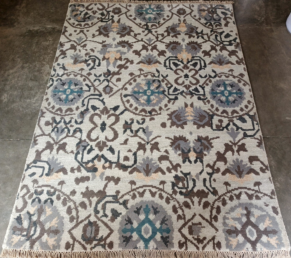 Decorative rug with intricate pattern on a concrete floor