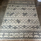 Patterned rug on a concrete floor