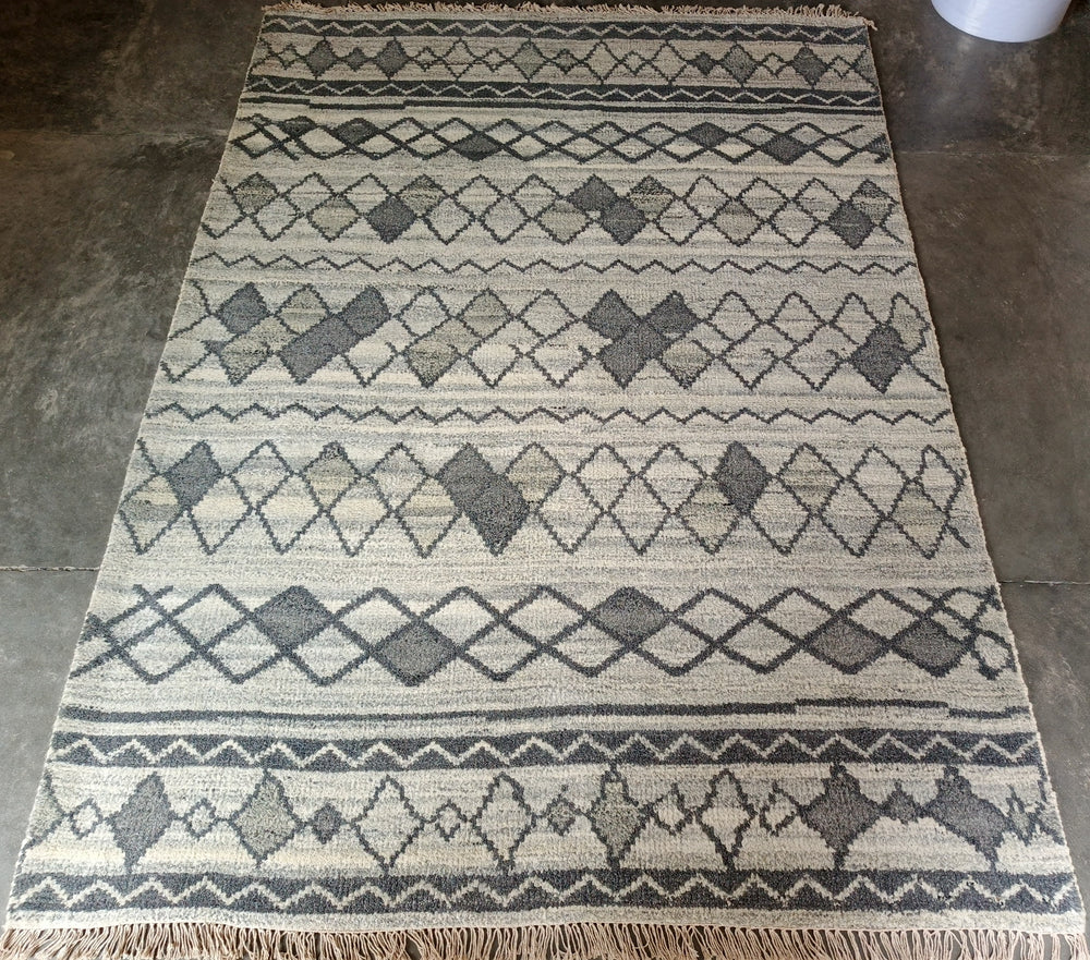 Patterned rug on a concrete floor
