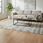 Living room with a gray sofa, wooden coffee table, and decorative elements.