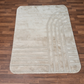 Beige patterned rug on a wooden floor