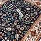 Close-up of a patterned rug with a visible brand tag.