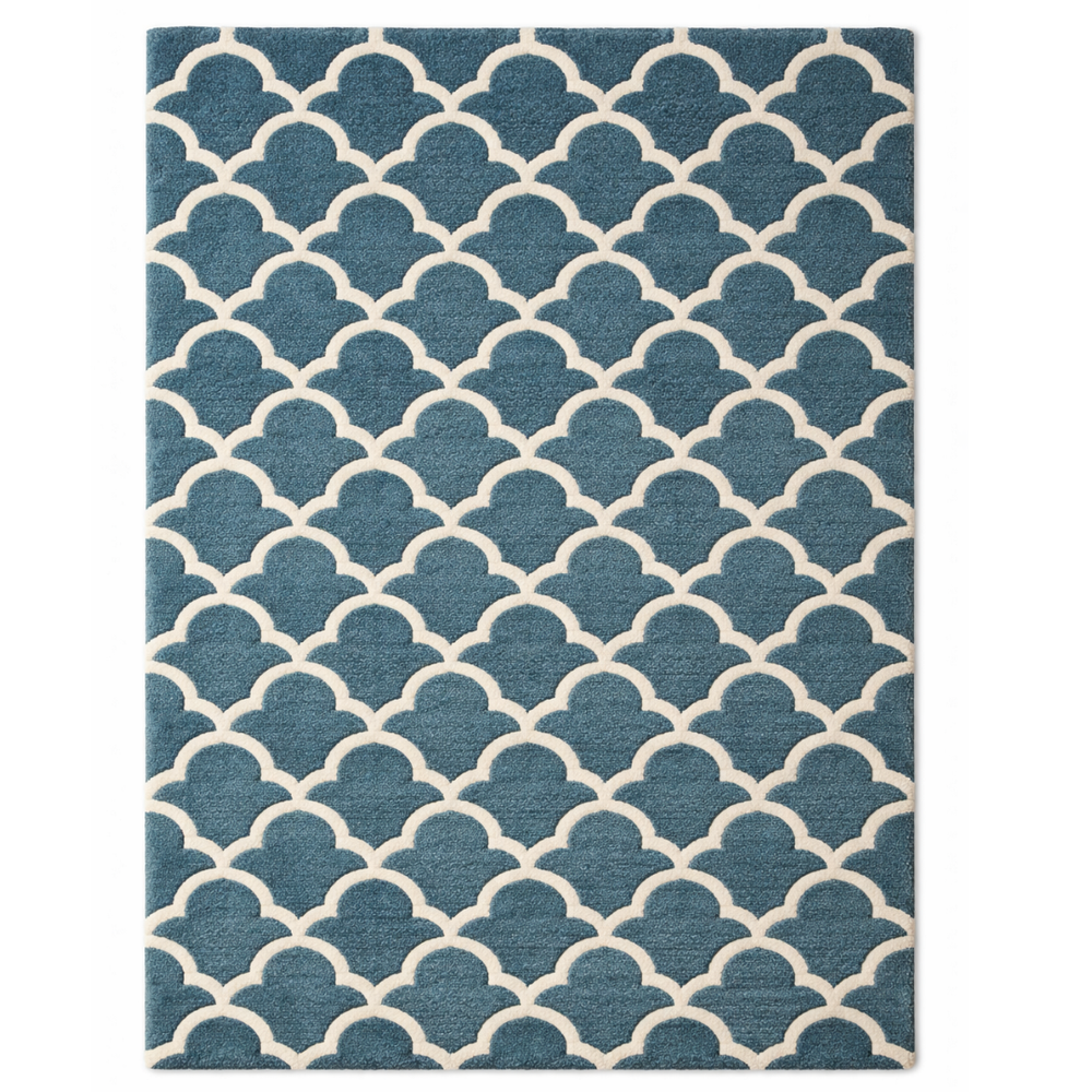 Blue and beige patterned rug on a white background