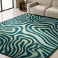Teal and white wavy patterned rug in a living room setting.