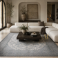 Modern living room with a sectional sofa, coffee table, and decorative elements.