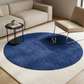Blue round rug with a brand logo in a living room setting