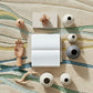 Collection of decorative items including vases and a book on a textured surface.