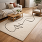 Living room with a decorative rug featuring abstract black line art on a beige background.