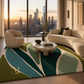A modern living room with a large abstract area rug in teal, green, cream, and olive tones, styled with a curved sofa, armchair, round coffee table, and a city skyline visible through floor-to-ceiling windows.