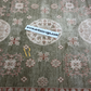 Close-up of a patterned rug with a visible brand label.