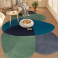 Three round rugs in blue, green, and gray on a wooden floor with a cat on a white cushion.
