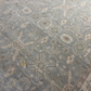 Close-up of a patterned rug with floral designs on a blue background