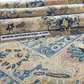 Close-up of patterned rugs with a visible brand label at the bottom.