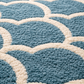 Close-up of a blue and white geometric patterned rug