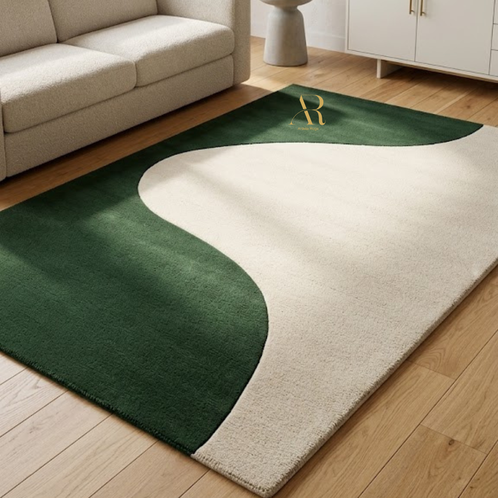 Green and beige rug on a wooden floor with a sofa in the background