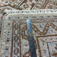 Patterned rug with a measuring tape indicating dimensions