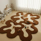 Brown and white wavy rug on a light wooden floor with toys around it.