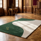Two-tone green and beige rug with a logo on a wooden floor.