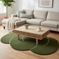 Living room with a beige sectional sofa, wooden coffee table, and green round rugs.