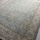 Close-up of a patterned rug with floral designs on a light background