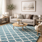 Living room with a blue patterned rug, beige sofa, and wooden coffee table.