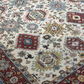 Close-up of a patterned rug with intricate designs and colors.