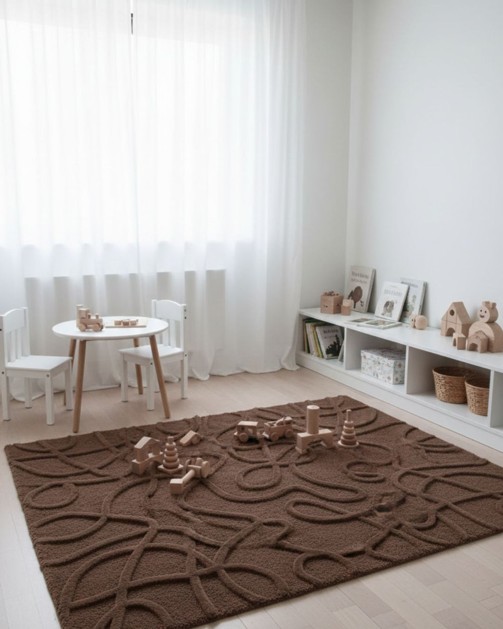 Children's playroom with a brown textured rug, white furniture, and toys.