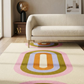 Modern living room with a colorful abstract rug on a light wood floor.