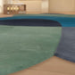 Close-up of a pool deck with green and blue tiles.