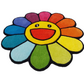 Colorful flower-shaped rug with a smiling face on a white background