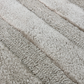 Beige patterned rug on a wooden floor