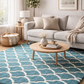 Living room with a blue patterned rug, beige sofa, and wooden coffee table.