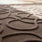 Close-up of a textured brown rug with circular patterns