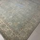 Patterned rug with a visible brand label on a tiled floor