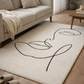 Beige rug with black abstract design in a living room setting