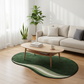 Living room with a green rug, beige sofa, and wooden coffee table.