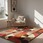 Colorful geometric-patterned rug in a living room with a chair and side table.