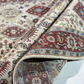 Close-up of patterned rugs with intricate designs on a light background