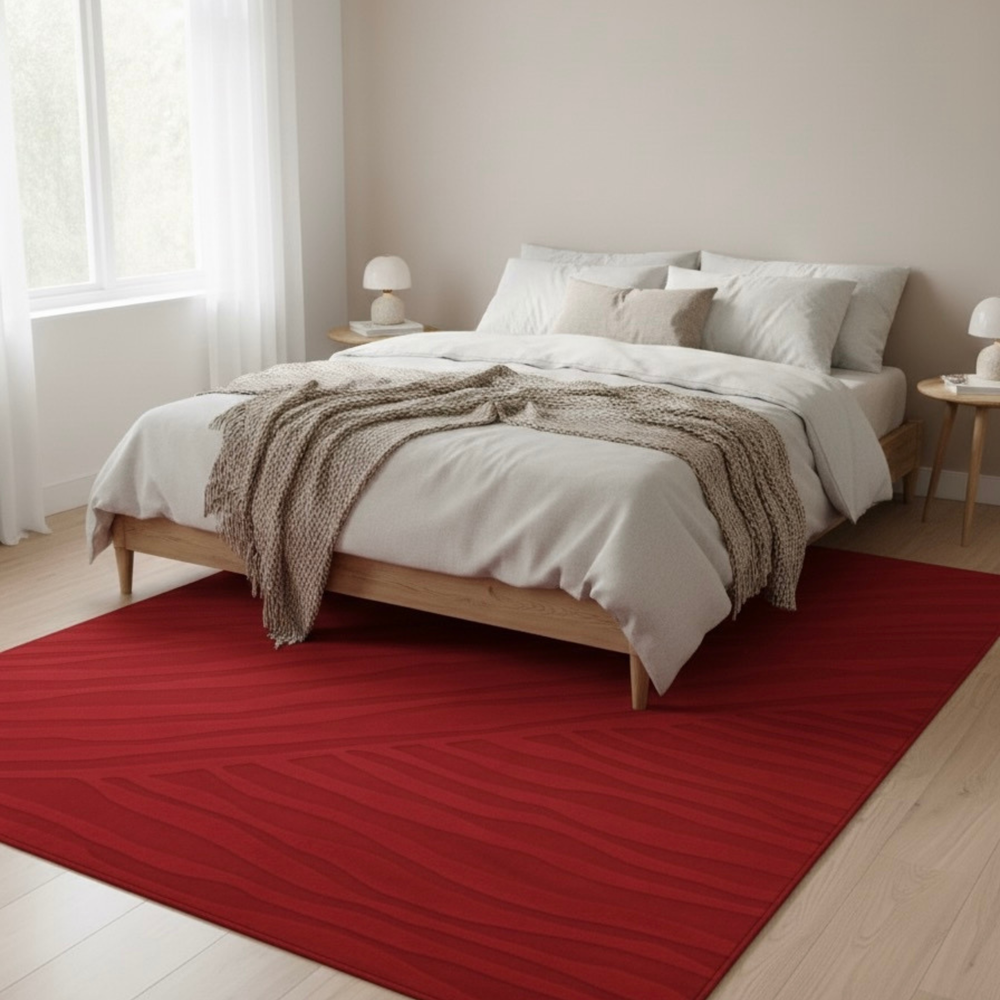 Bedroom with a red rug, wooden bed frame, and white bedding.