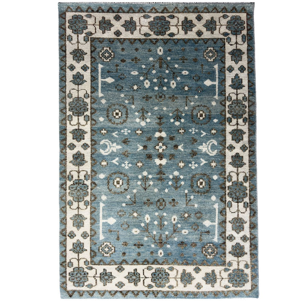 Decorative rug with a blue and beige pattern on a white background