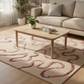 Living room with a beige sofa, wooden coffee table, and patterned rug.