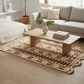 Living room with a beige sofa, wooden coffee table, and patterned rug.